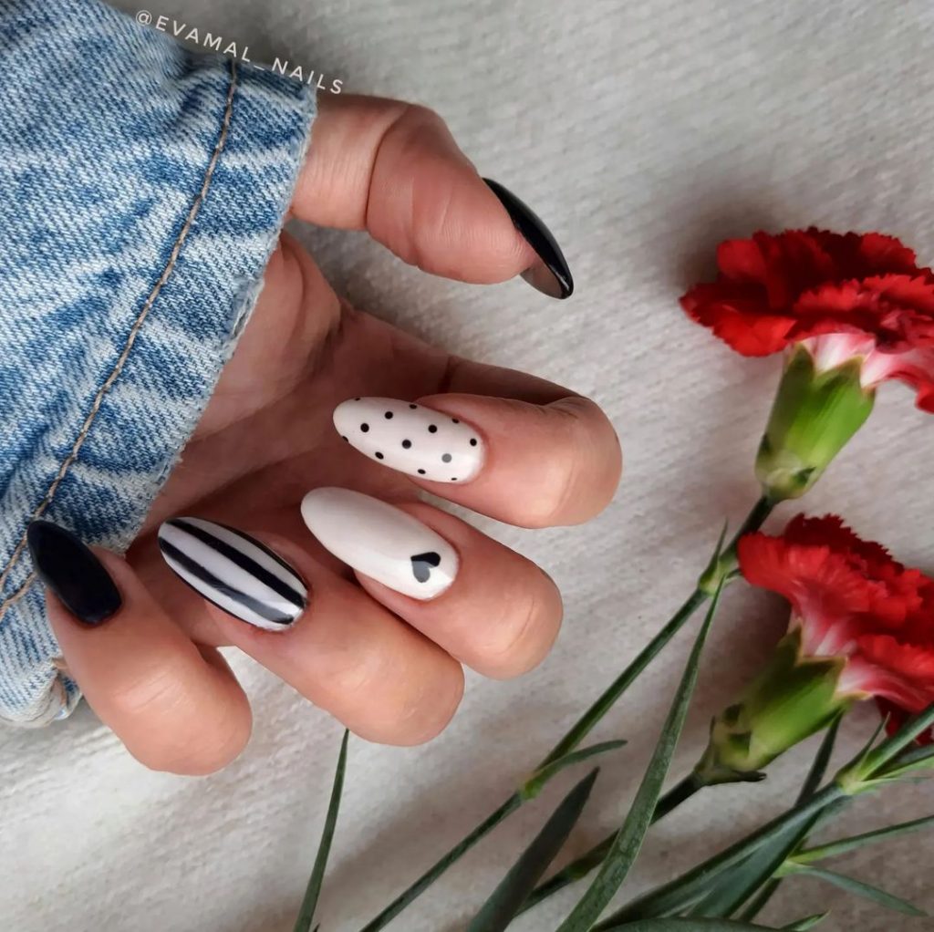 White and black nail art with black hearts 
