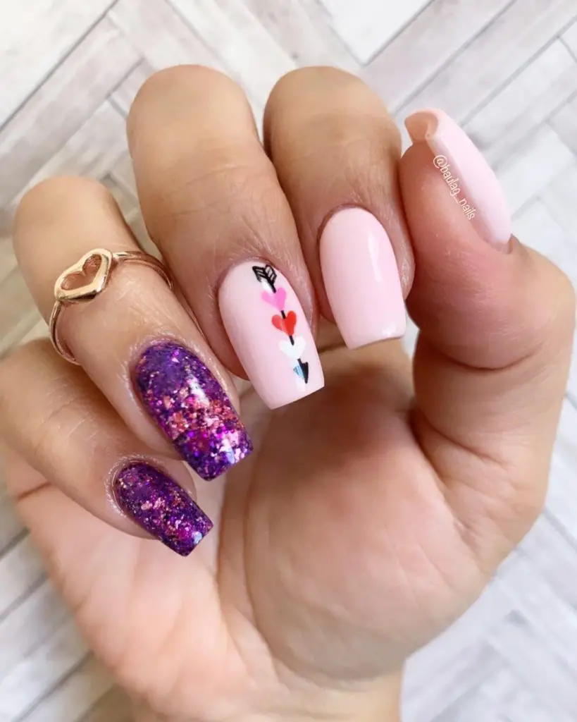 Purple nail art design with hears for february nail inspiration 