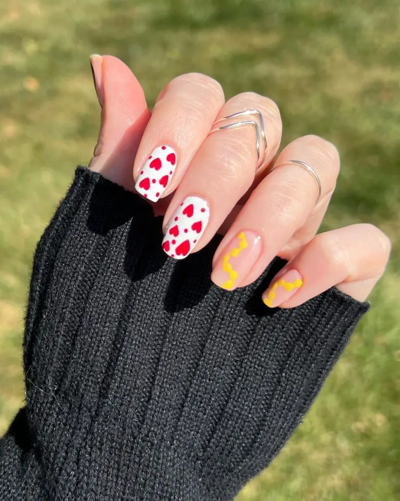 white nails with red heart