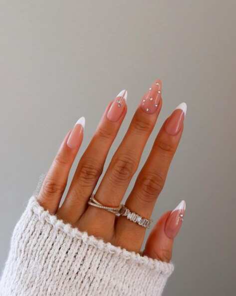 white French nails with rhinestones detailed.