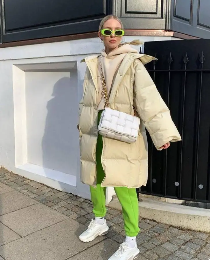 Cheerful neon green sweatpants and nude sweater for sporty outfit