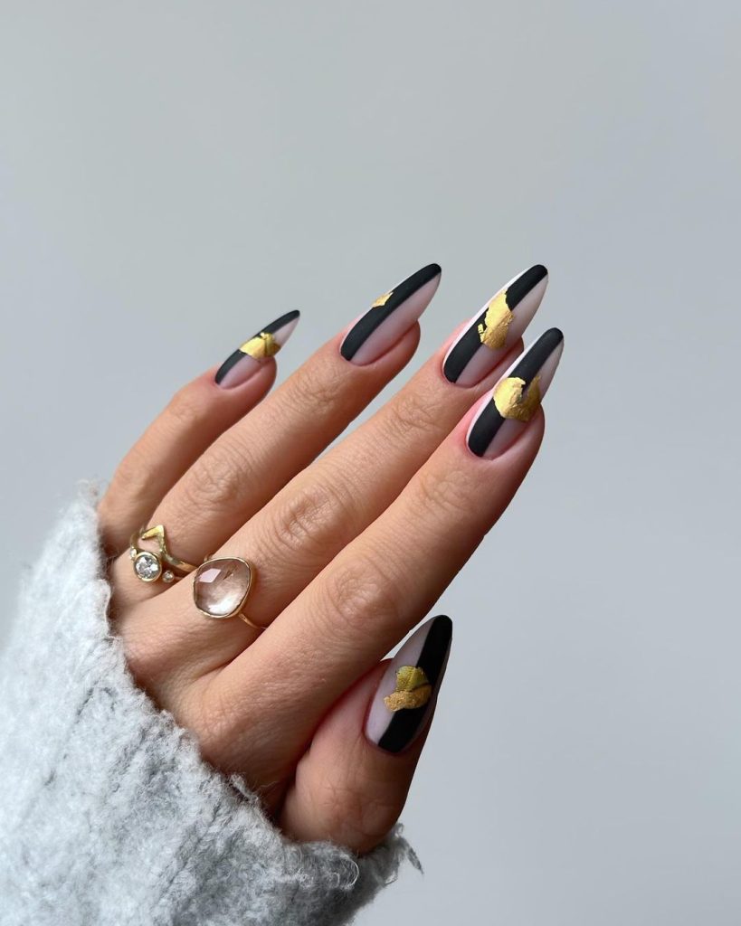 Almond nail ideas in black and gold with matte coat