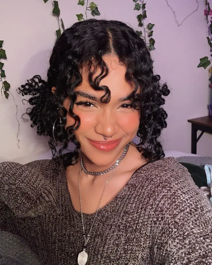 curly curtain bangs with low pigtails